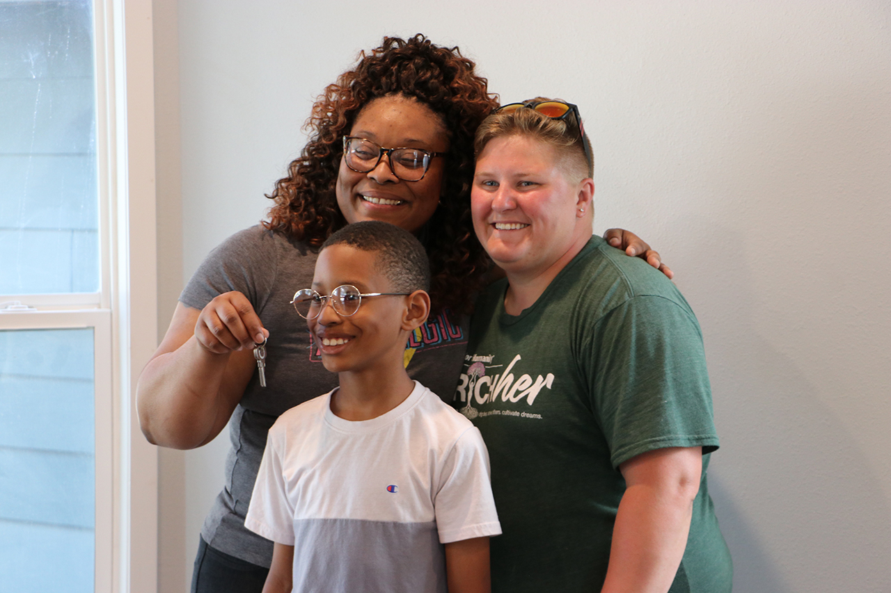 Happy family accepting keys to Habitat house.
