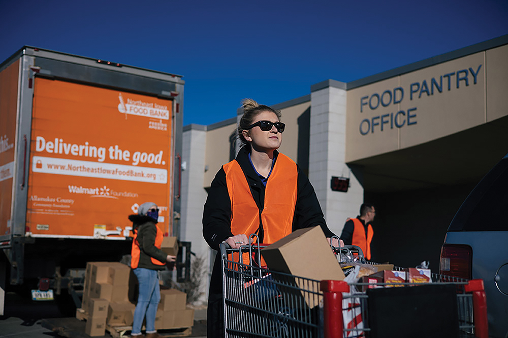 A volunteer helps outside of the Northeast Iowa Food Bank